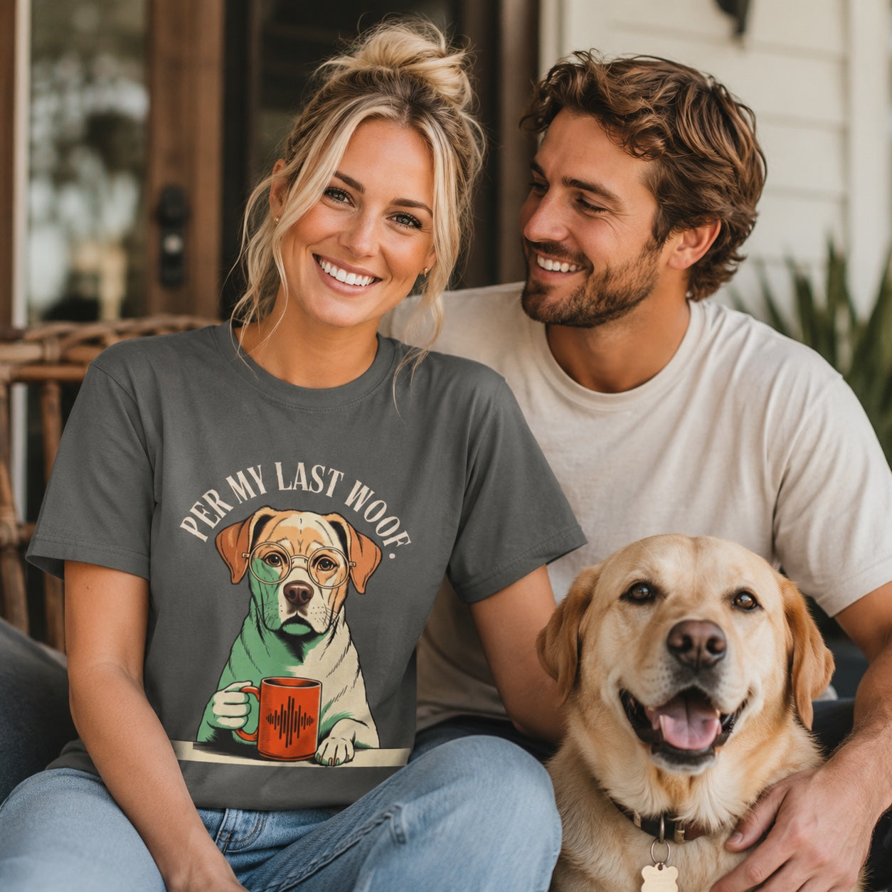 Couple sitting together with their Labrador on a porch with flag decor, wearing pepper 'Per My Last Woof' t-shirts