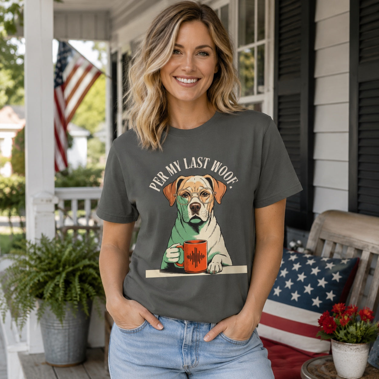 Woman standing on a porch with patriotic decor, wearing pepper colorful Labrador coffee t-shirt