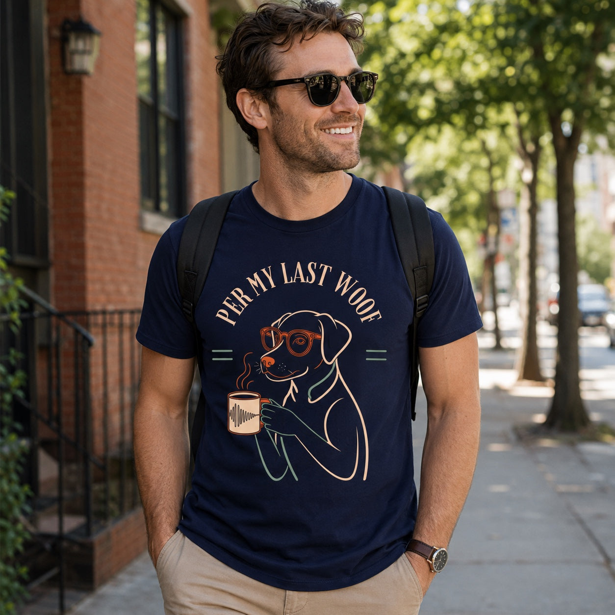 Man walking a city street with a backpack, wearing true navy 'Per My Last Woof' dog t-shirt