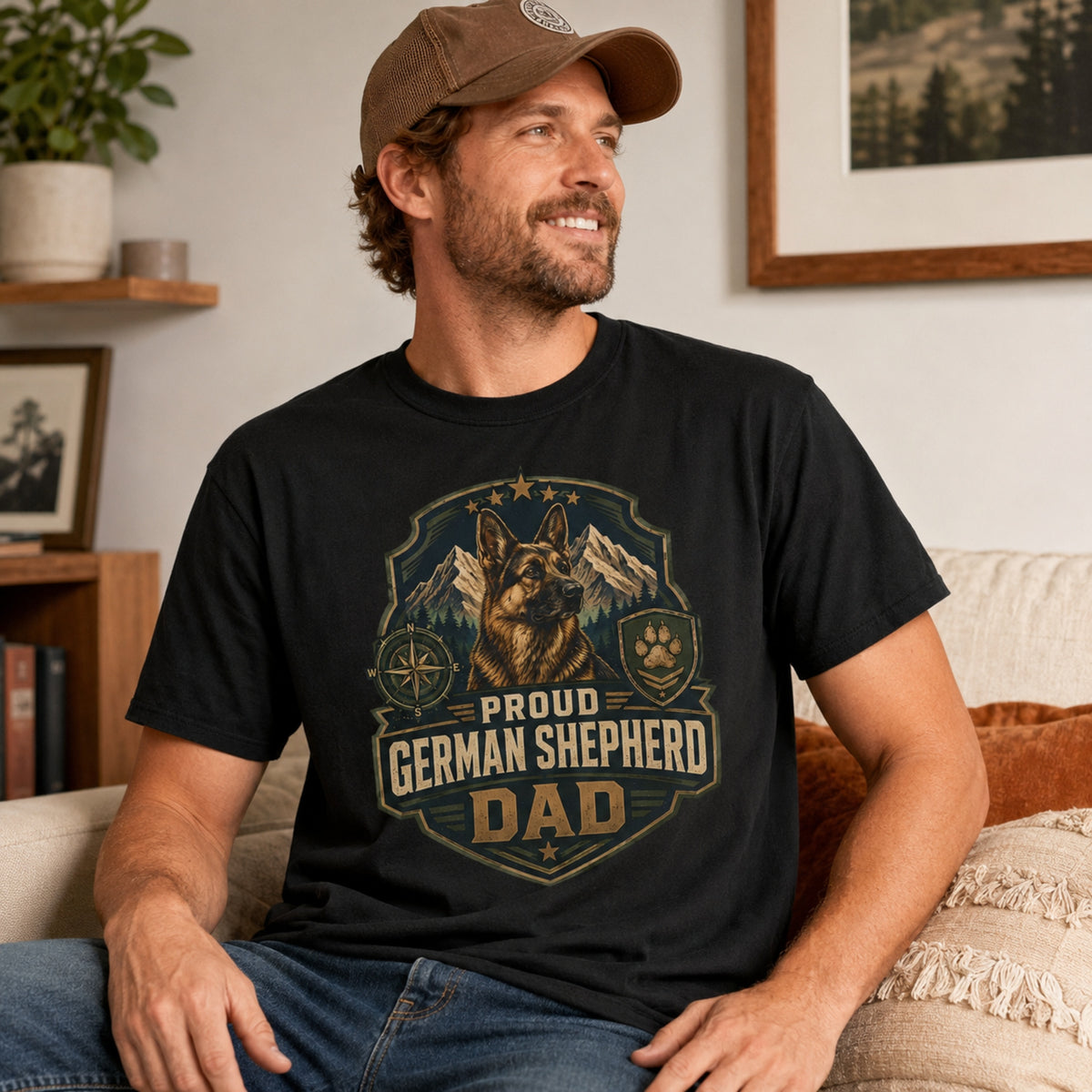 Man wearing a black Proud German Shepherd Dad T-shirt in a casual living room.