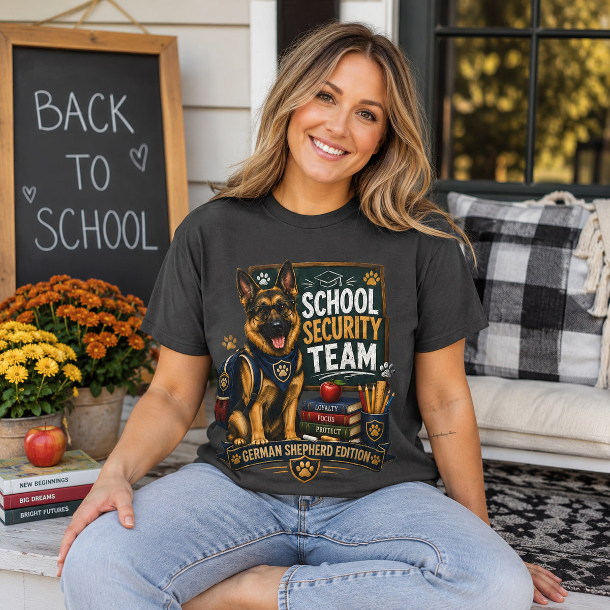 Woman sitting on a porch near a 'Back to School' chalkboard sign, wearing graphite 'School Security Team' German Shepherd t-shirt