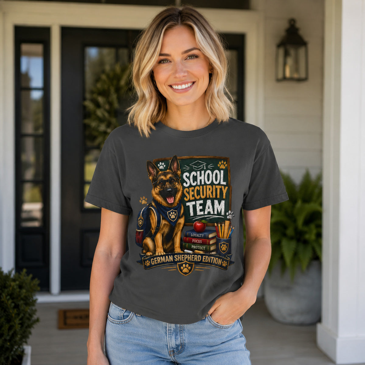 Woman standing on a porch wearing graphite 'School Security Team' German Shepherd t-shirt