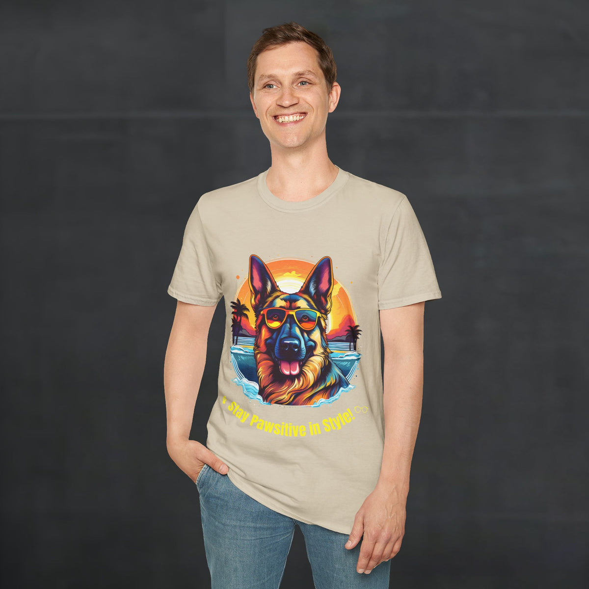 Male model wearing sand color German Shepherd “Stay Pawsitive in Style” T-shirt with colorful retro sunset beach dog graphic.