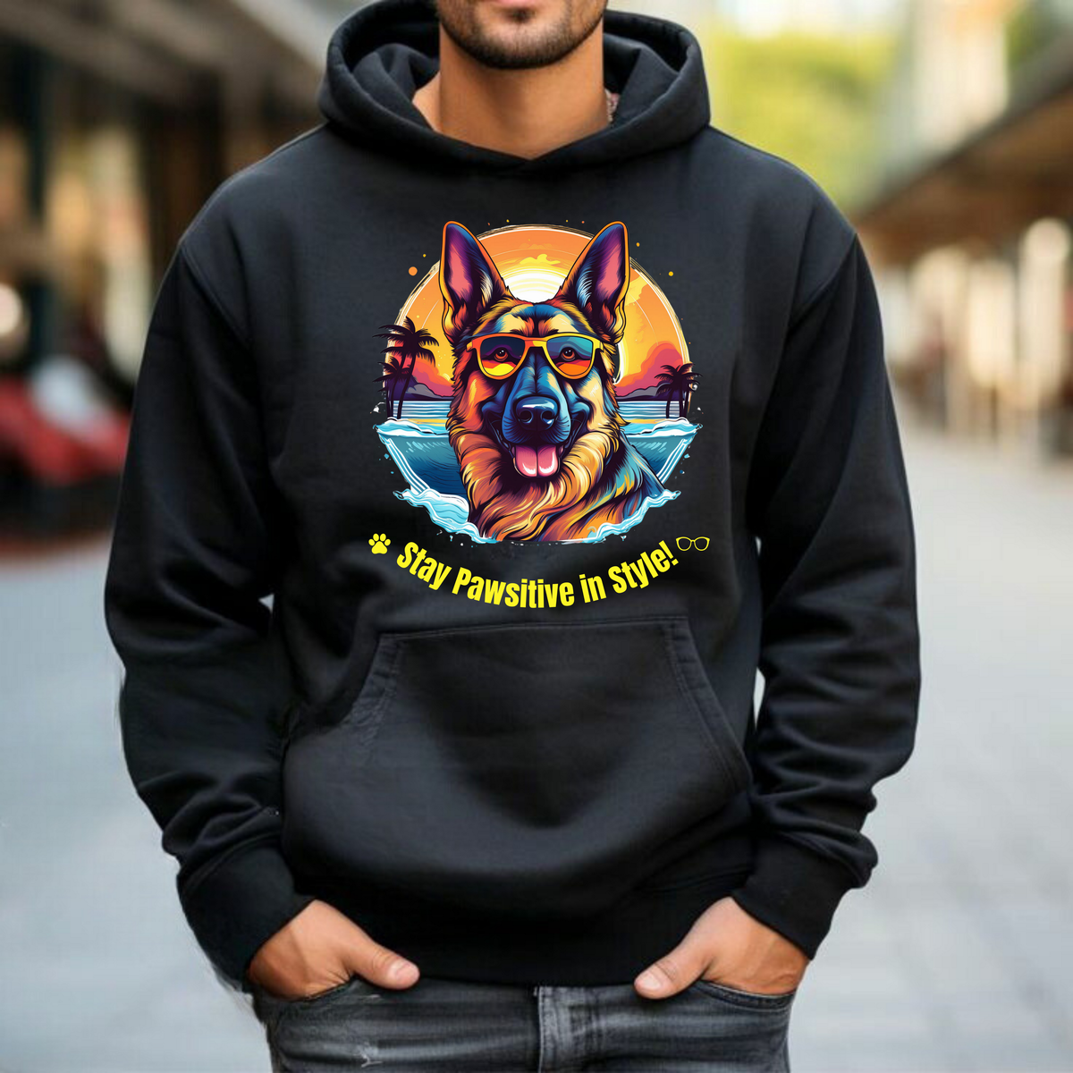 Man wearing a black Stay Pawsitive in Style hoodie with a German Shepherd graphic on an urban walkway