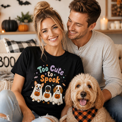 Model wearing a black Too Cute to Spook t-shirt with a ghost pup graphic in a Halloween scene