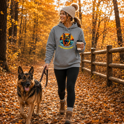 Dog lover wearing Steel Grey German Shepherd hoodie while walking a German Shepherd through autumn leaves.
