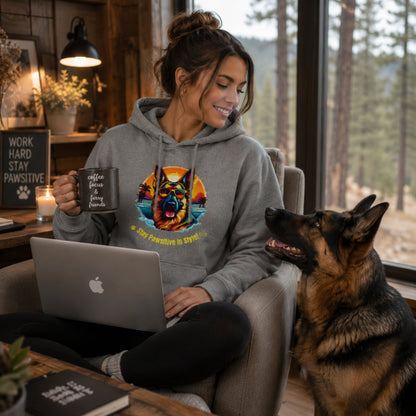 Woman working from home wearing Steel Grey German Shepherd hoodie beside her German Shepherd dog.